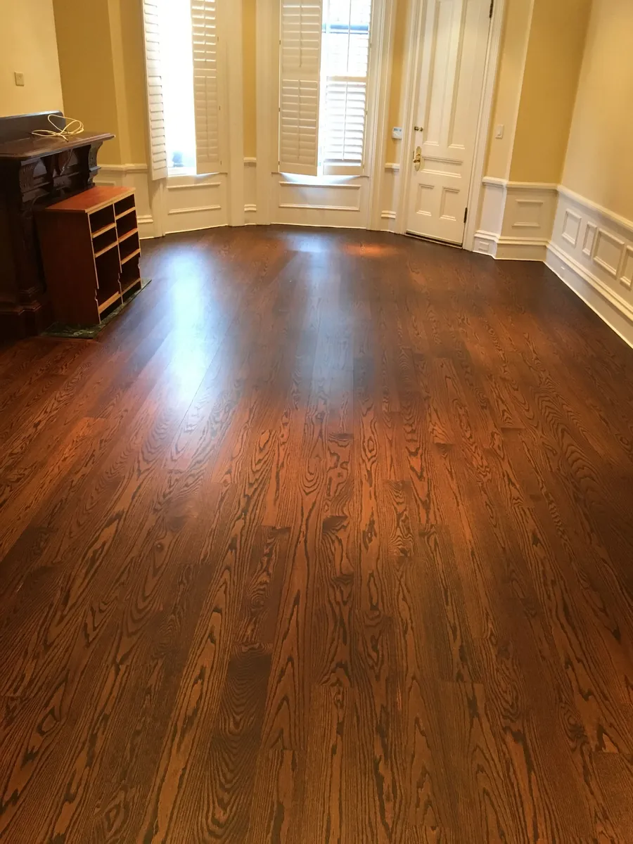 Red oak floor with a rich walnut stain and a satin finish in a sunlit parlor